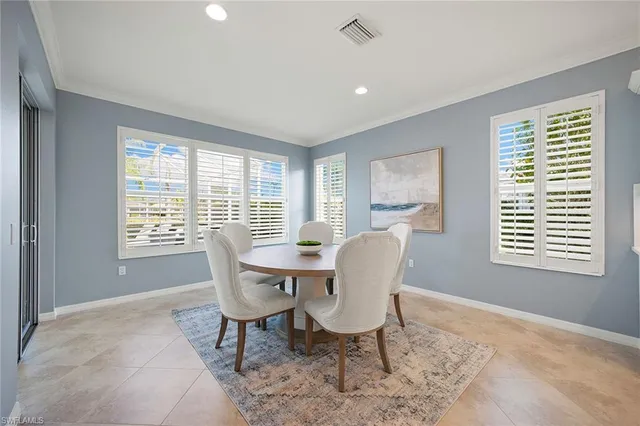 a dining room with furniture a rug and wooden floor