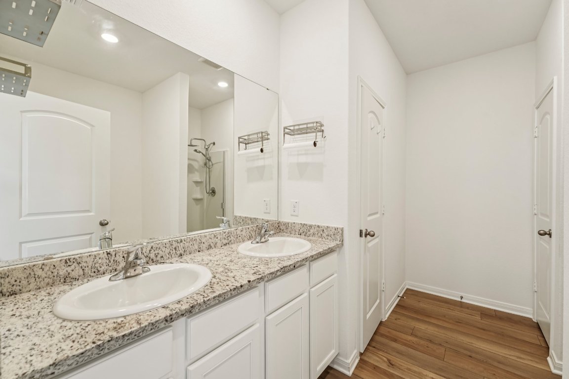 571 Aplite Pass Maxwell, TX 78656 - Photo 21 of 29 a bathroom with a granite countertop double vanity sink and mirror