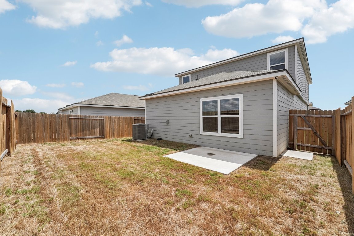 571 Aplite Pass Maxwell, TX 78656 - Photo 8 of 29 a front view of a house with a yard and garage