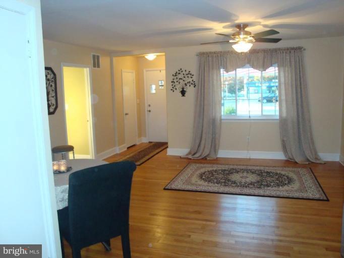 8507 Philadelphia Road Rosedale, MD 21237 - Photo 10 of 14 a bedroom with a bed and a table in it