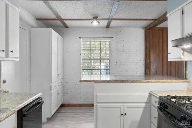 a kitchen with a stove and a window