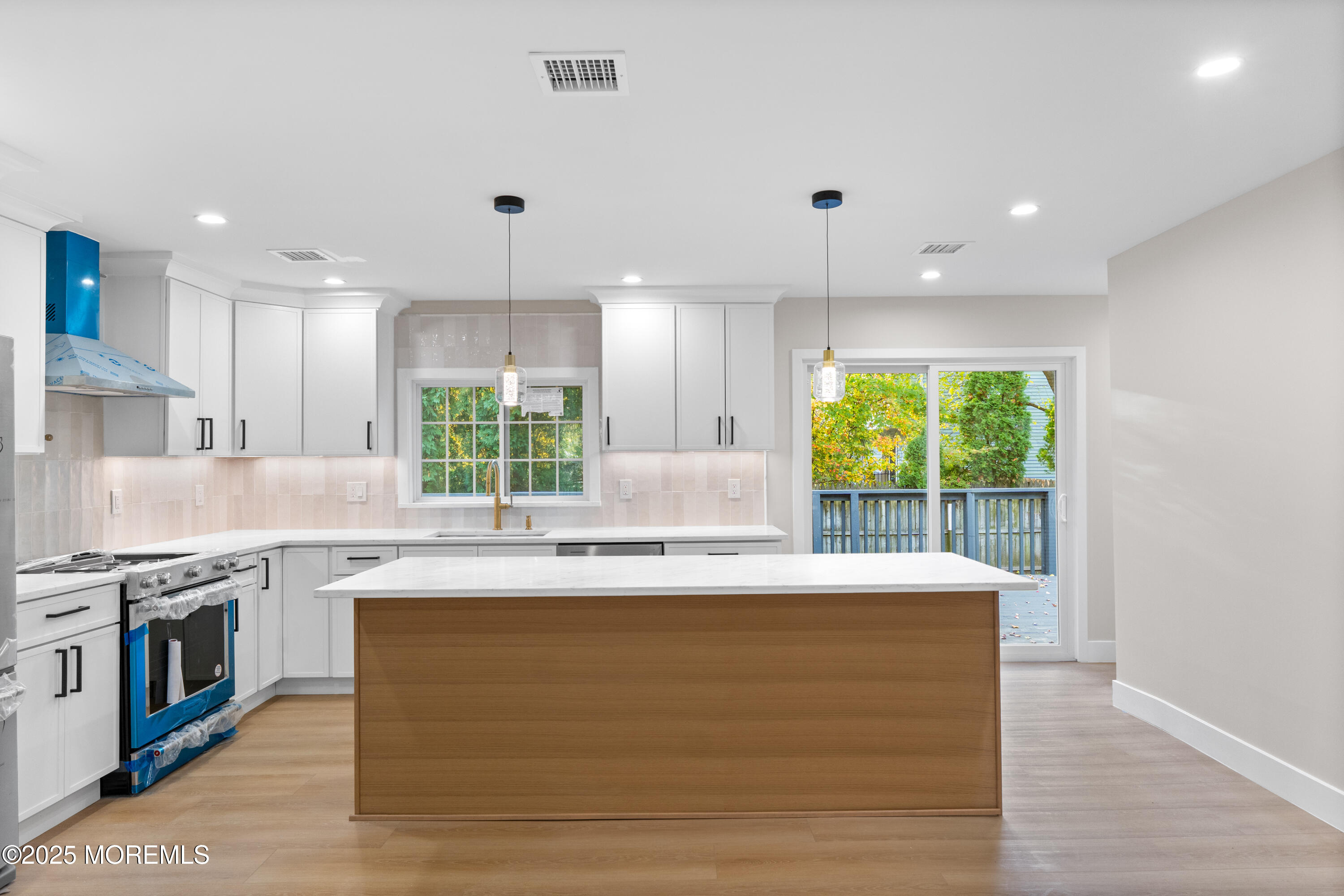 75 Ohio Avenue Middletown, NJ 07758 - Photo 12 of 40 a large kitchen with granite countertop a stove and a sink