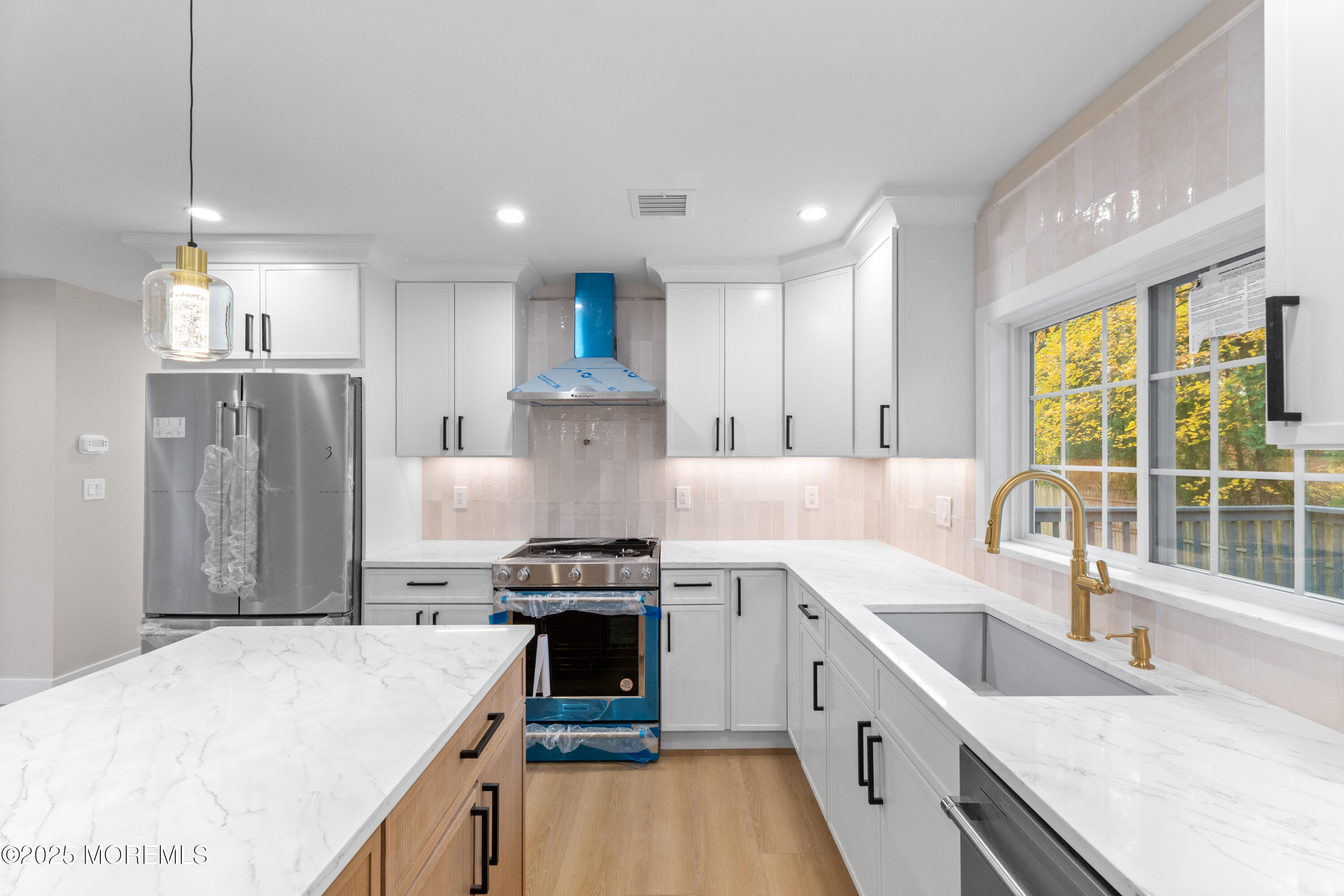 75 Ohio Avenue Middletown, NJ 07758 - Photo 14 of 40 a large kitchen with stainless steel appliances granite countertop a sink stove and refrigerator