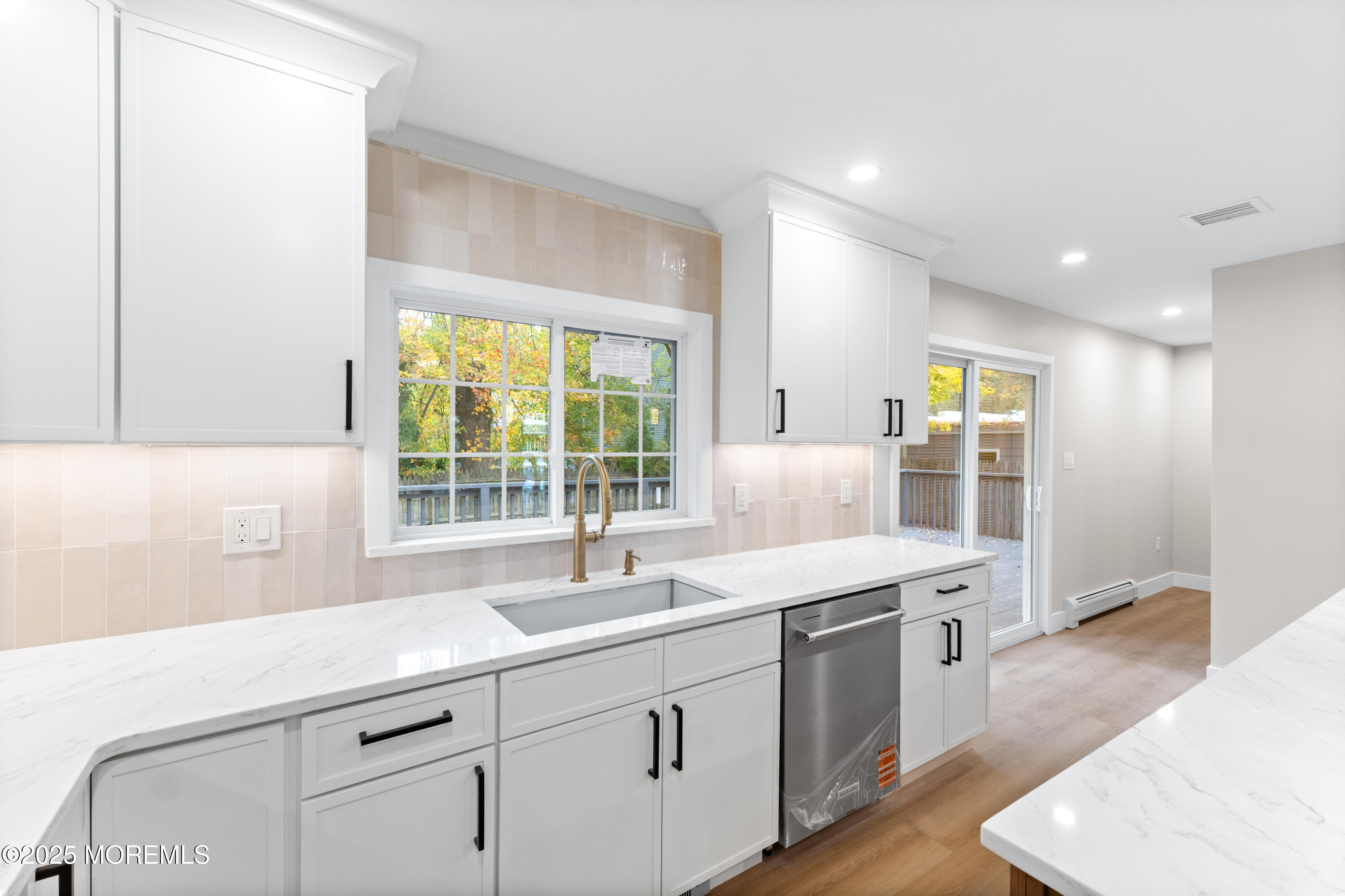 75 Ohio Avenue Middletown, NJ 07758 - Photo 16 of 40 a kitchen with a sink stove and cabinets