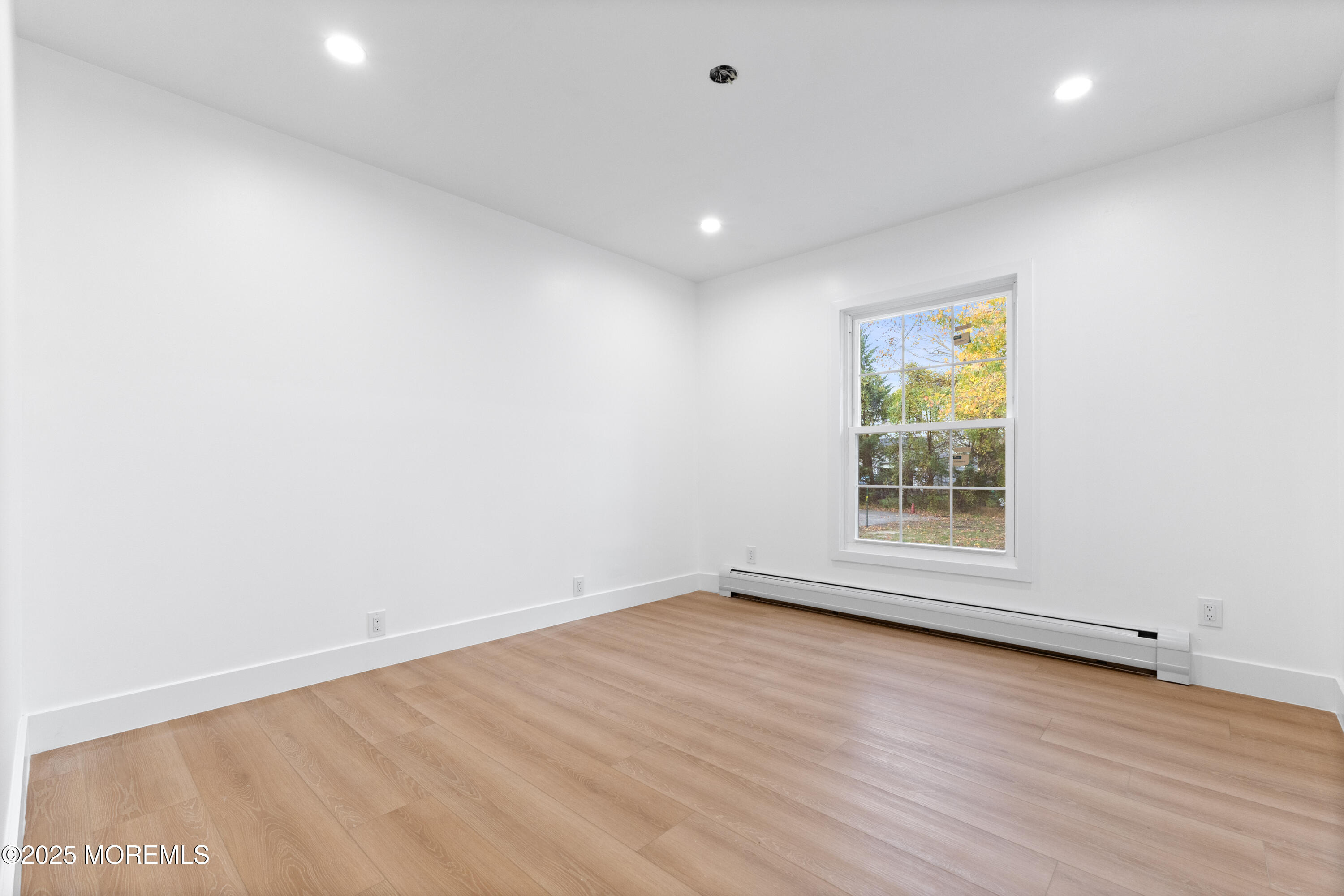75 Ohio Avenue Middletown, NJ 07758 - Photo 25 of 40 an empty room with wooden floor and natural light