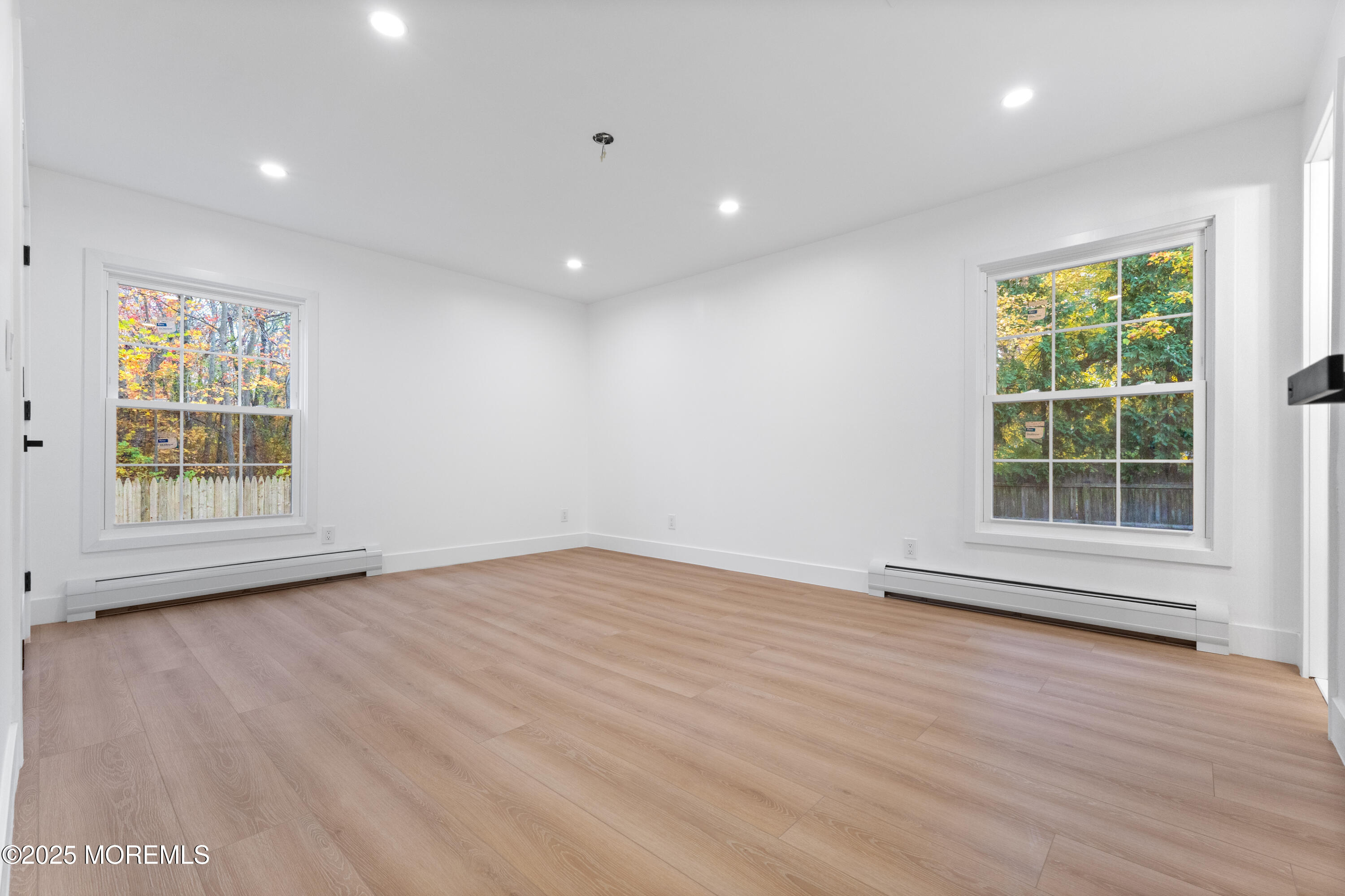 75 Ohio Avenue Middletown, NJ 07758 - Photo 27 of 40 an empty room with wooden floor and windows