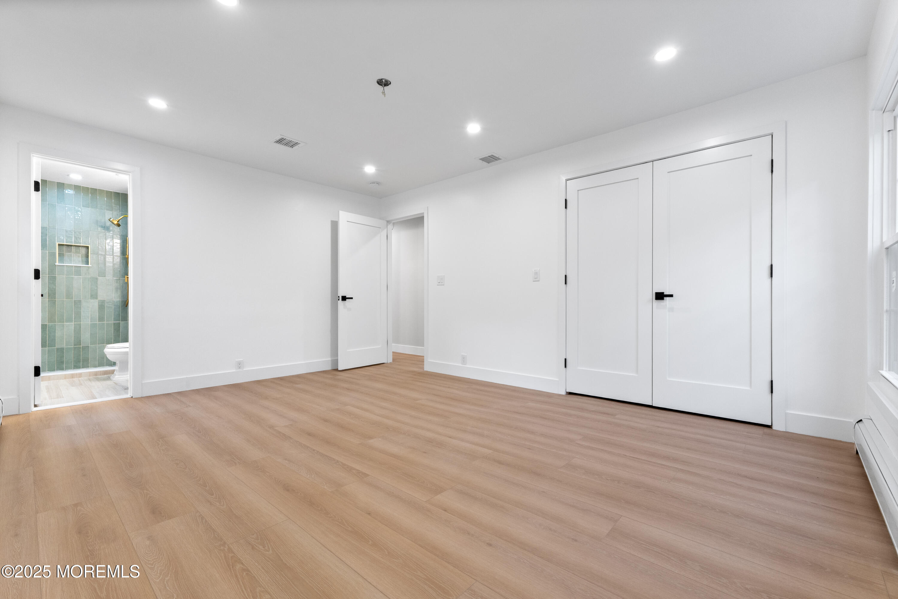 75 Ohio Avenue Middletown, NJ 07758 - Photo 28 of 40 a view of an empty room with wooden floor
