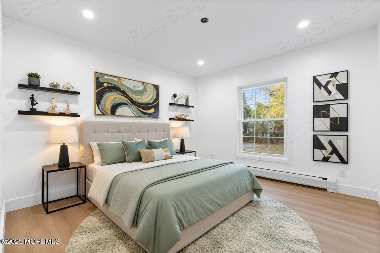 75 Ohio Avenue Middletown, NJ 07758 - Photo 32 of 40 a bedroom with a bed and painting on the wall