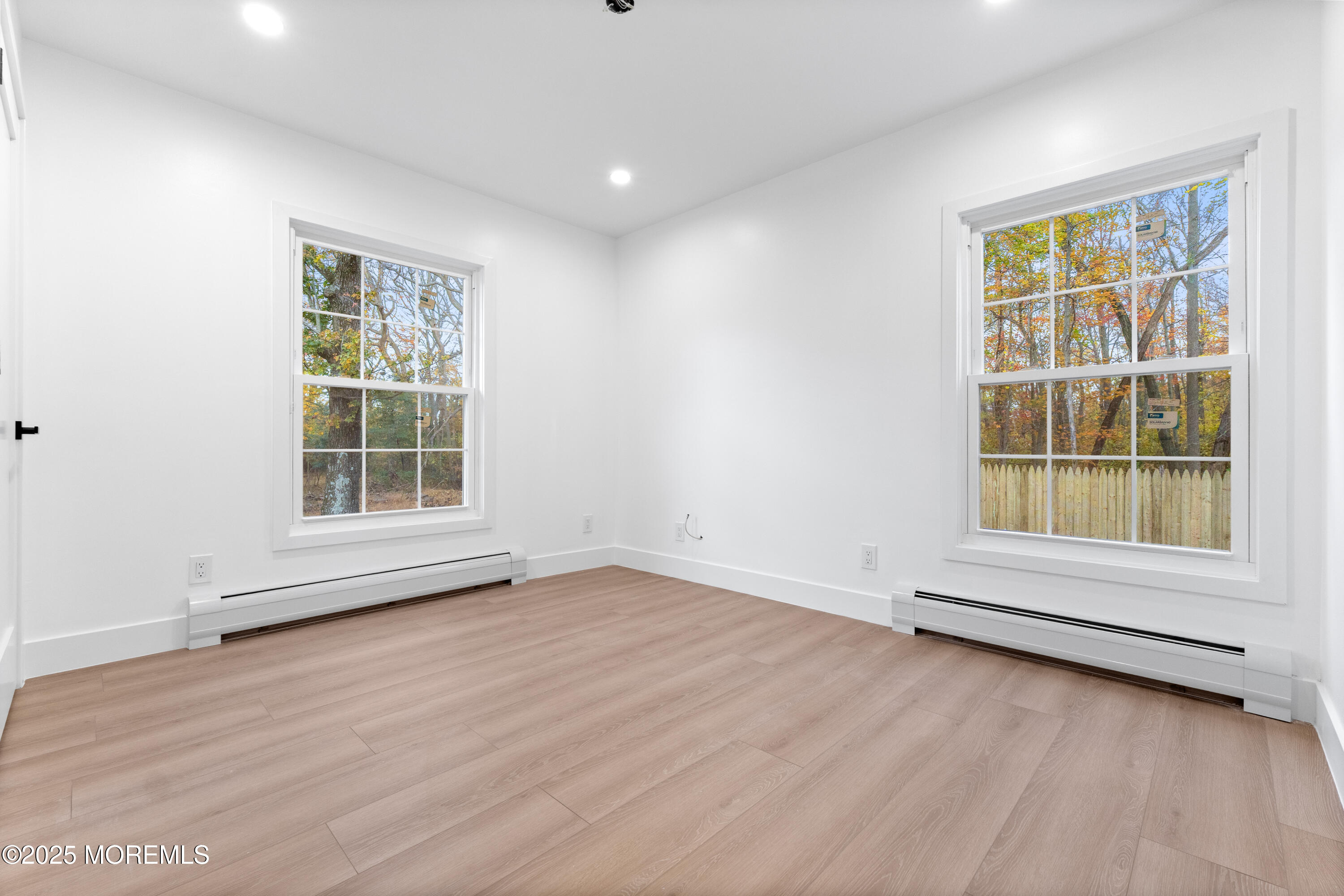 75 Ohio Avenue Middletown, NJ 07758 - Photo 34 of 40 an empty room with wooden floor and windows