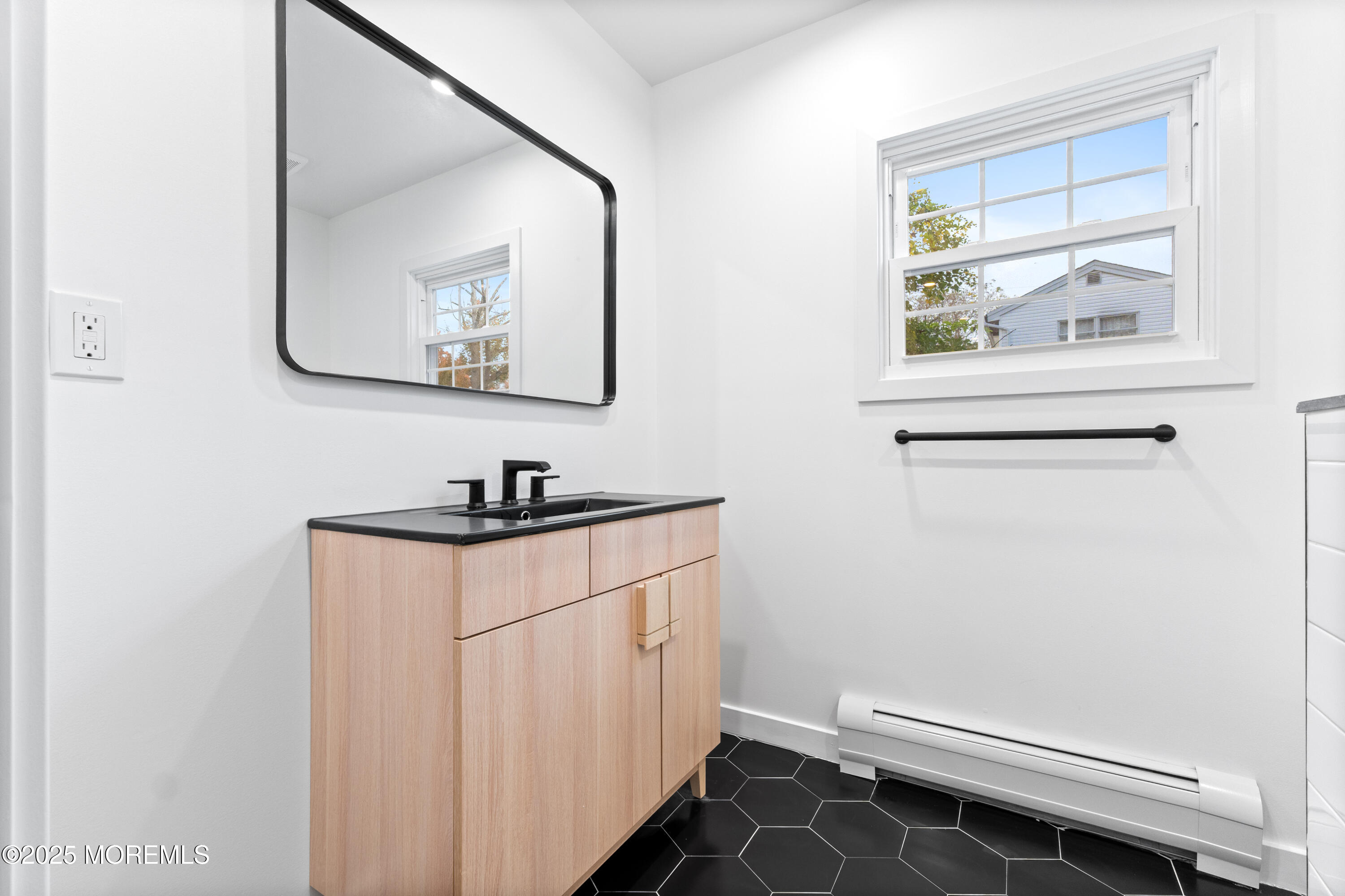 75 Ohio Avenue Middletown, NJ 07758 - Photo 36 of 40 a bathroom with a sink and a mirror