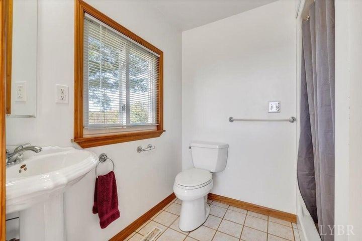 1775 Dickerson Road Goodview, VA 24095 - Photo 11 of 24 a bathroom with a sink toilet and shower