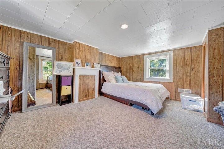 1775 Dickerson Road Goodview, VA 24095 - Photo 12 of 24 a bed room with a bed and a window