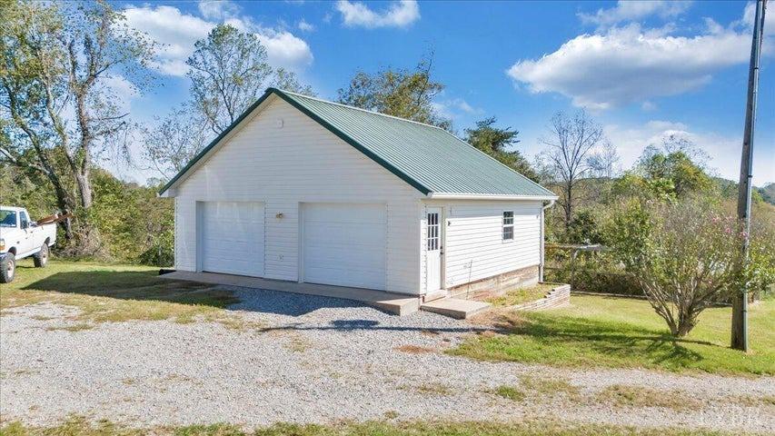 1775 Dickerson Road Goodview, VA 24095 - Photo 16 of 24 a view of a house with a yard and large tree