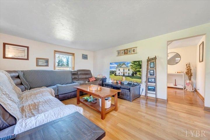 1775 Dickerson Road Goodview, VA 24095 - Photo 2 of 24 a living room with furniture and a wooden floor
