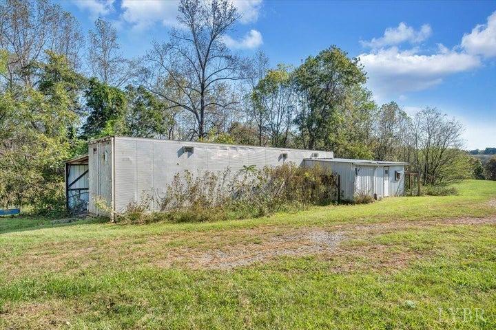1775 Dickerson Road Goodview, VA 24095 - Photo 22 of 24 a backyard of a house with large trees