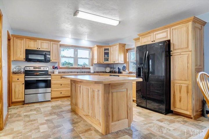 1775 Dickerson Road Goodview, VA 24095 - Photo 5 of 24 a kitchen with stainless steel appliances granite countertop a refrigerator stove and sink