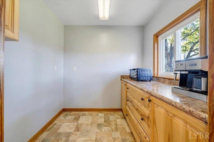 1775 Dickerson Road Goodview, VA 24095 - Photo 6 of 24 a kitchen with stainless steel appliances granite countertop a sink and a stove