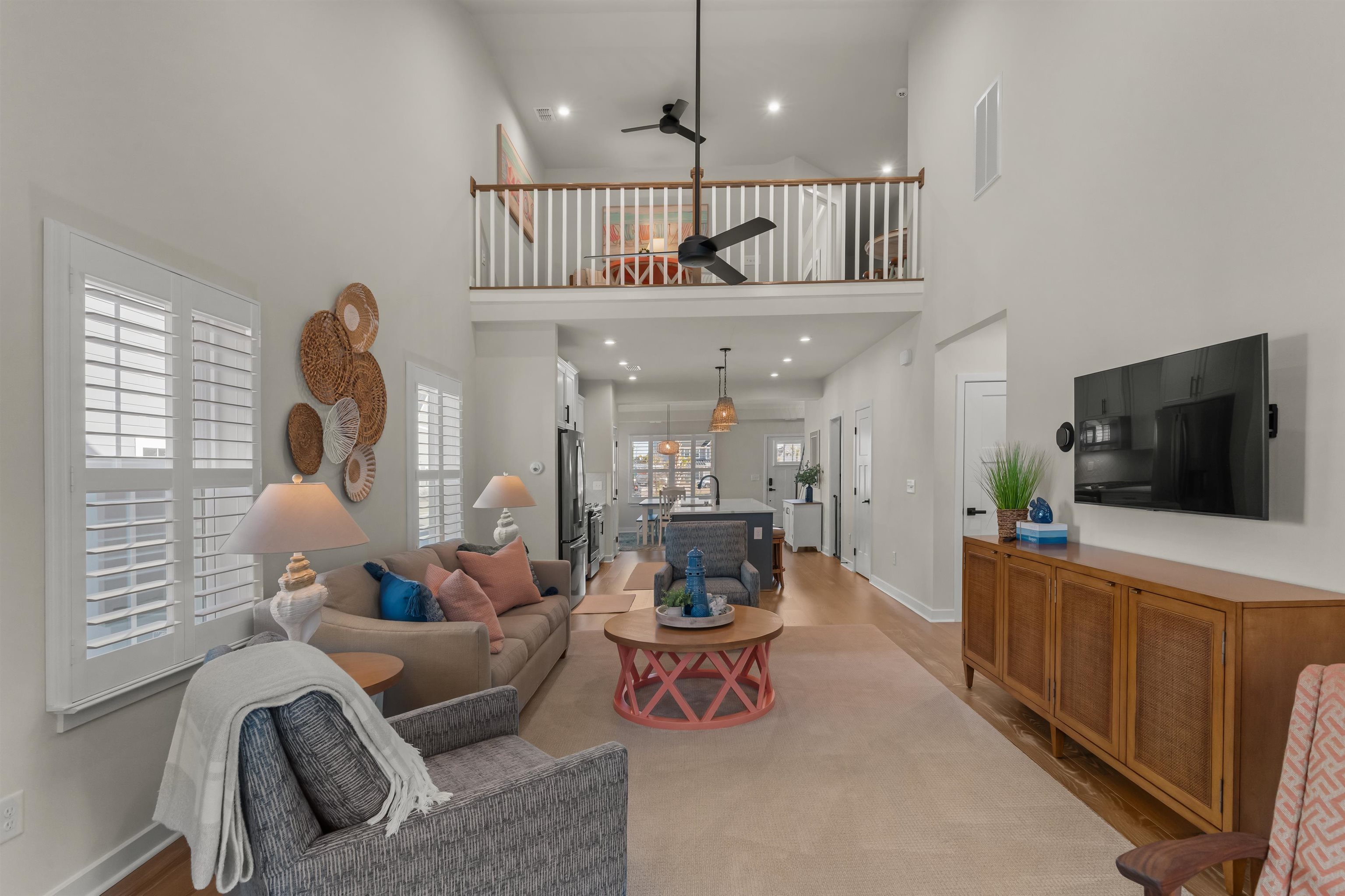 2519 Elowen Lane, Unit 9B Longs, SC 29568 - Photo 10 of 40 Living room featuring light wood-style floors, recessed lighting, and a towering ceiling