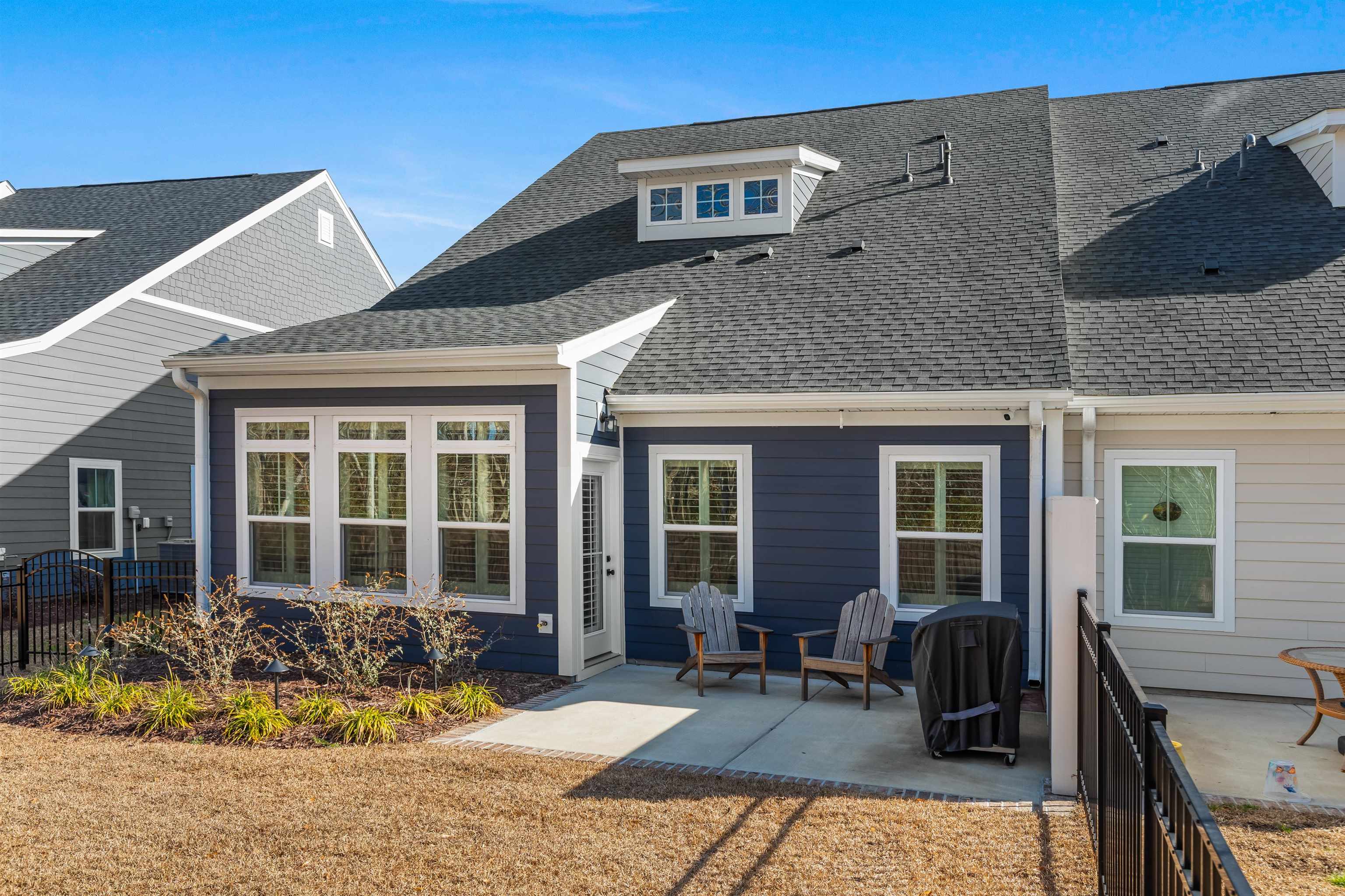 2519 Elowen Lane, Unit 9B Longs, SC 29568 - Photo 31 of 40 Back of house with a patio and roof with shingles