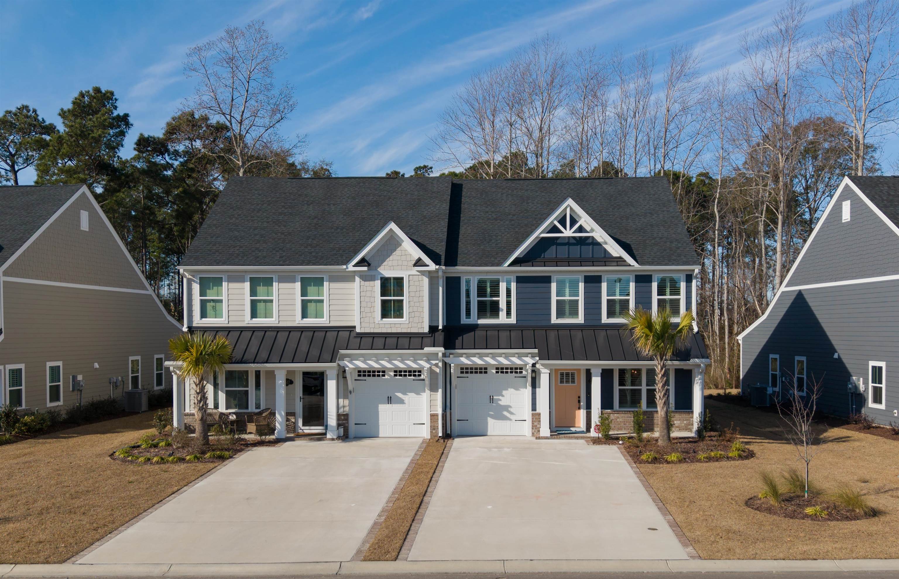2519 Elowen Lane, Unit 9B Longs, SC 29568 - Photo 32 of 40 View of front of house featuring a standing seam roof, a metal roof, driveway, a shingled roof, and an attached garage