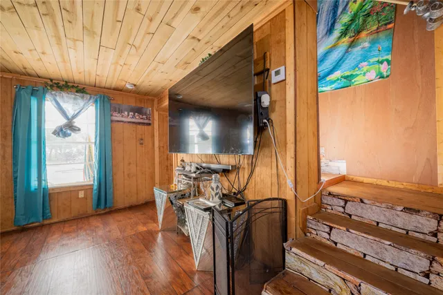 a bedroom with a bed and a night stand