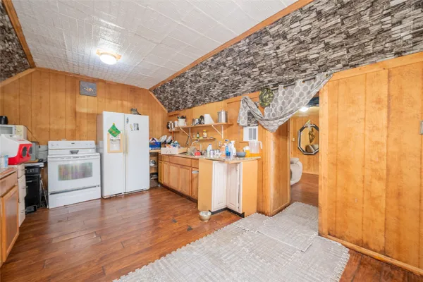 a kitchen with stainless steel appliances a stove a sink and a refrigerator