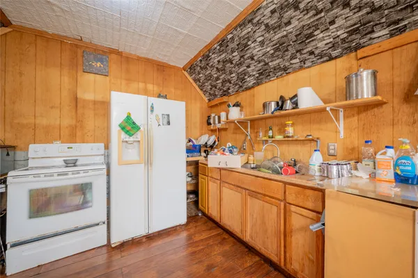 a kitchen with cabinets and wooden floor
