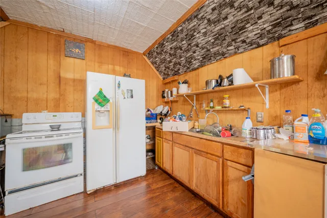a kitchen with cabinets and wooden floor