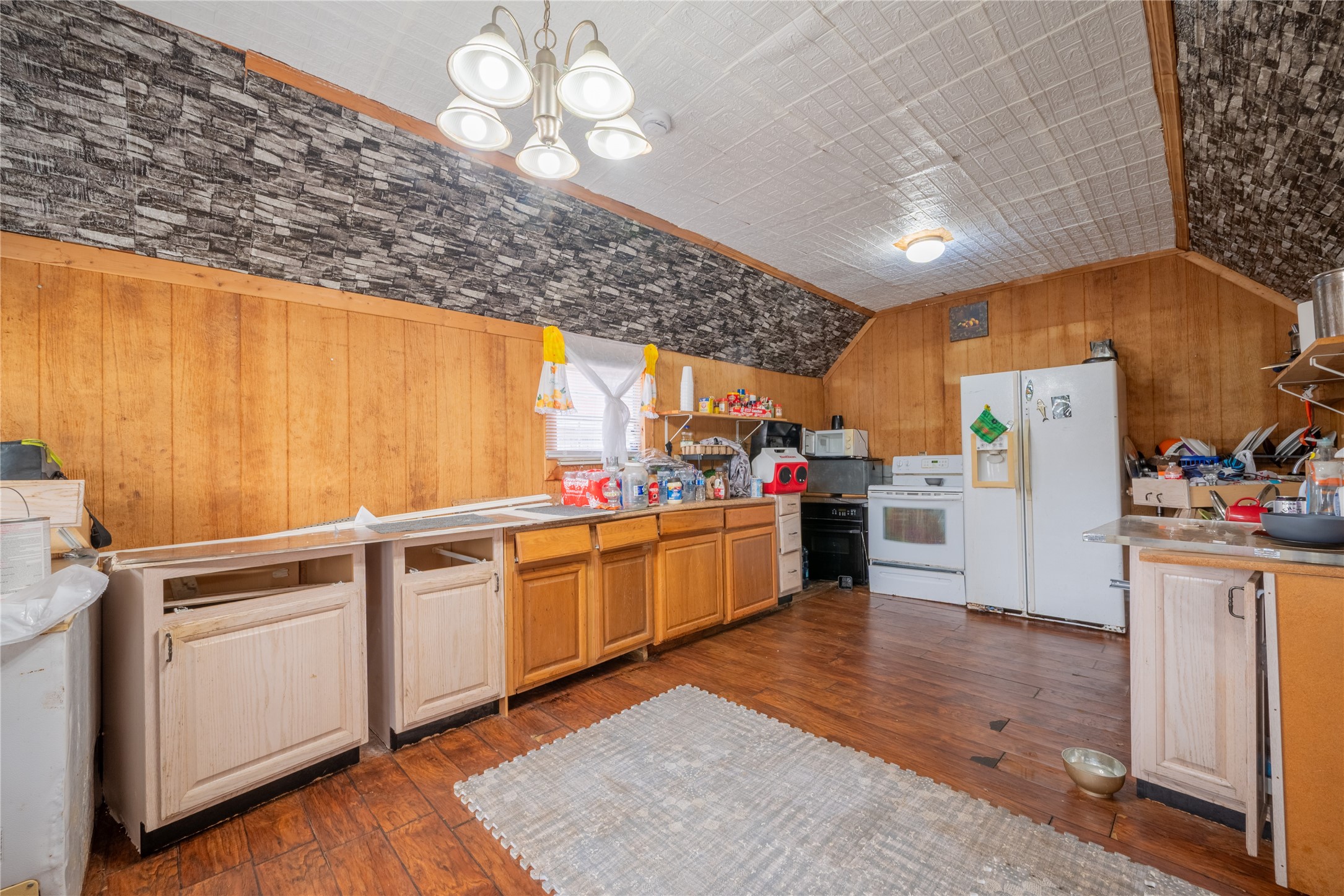 299 Mack Foster Street Winnie, TX 77665 - Photo 19 of 34 a kitchen with cabinets and wooden floor