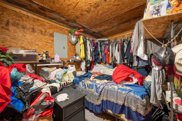 a bedroom with double bed and a couch