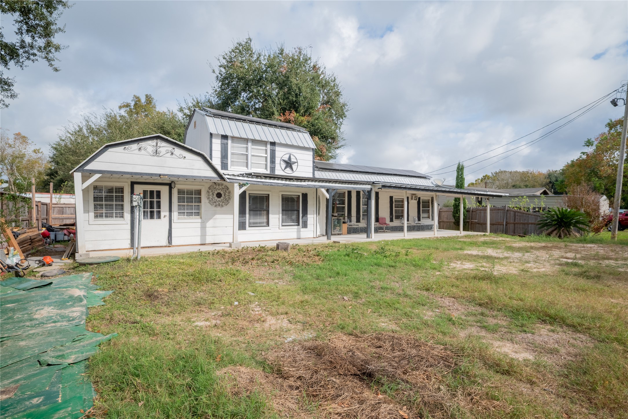 299 Mack Foster Street Winnie, TX 77665 - Photo 2 of 34 a front view of a house with a garden