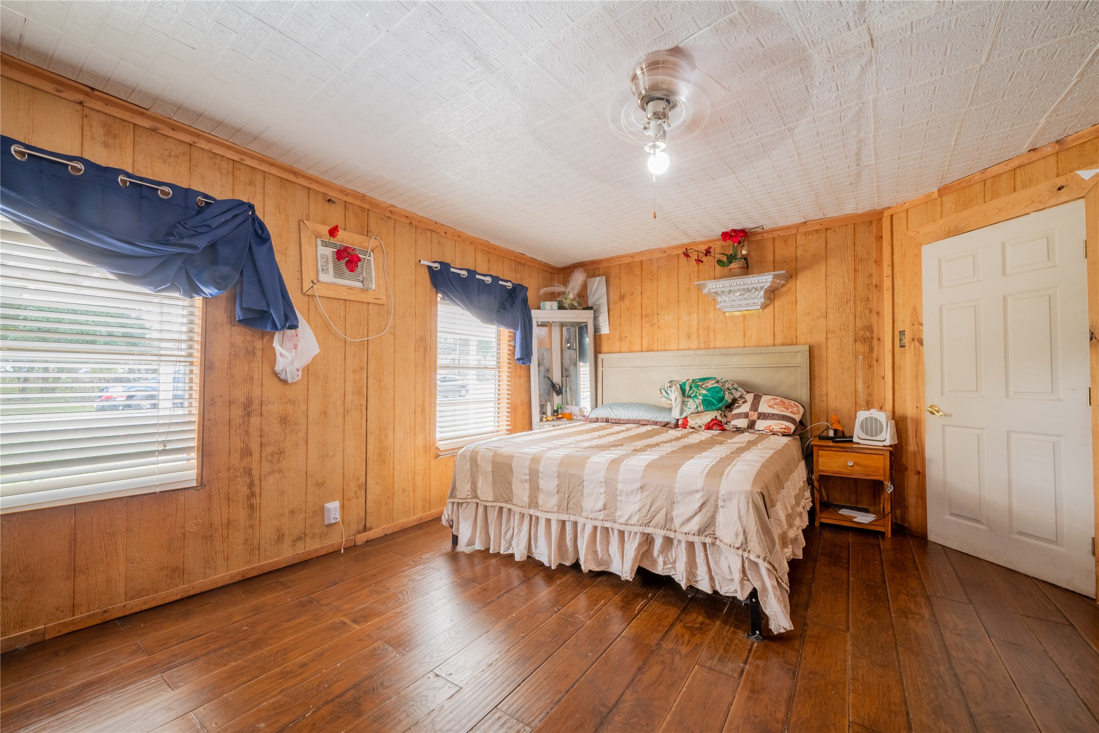 299 Mack Foster Street Winnie, TX 77665 - Photo 23 of 34 a bedroom with a bed and wooden floor