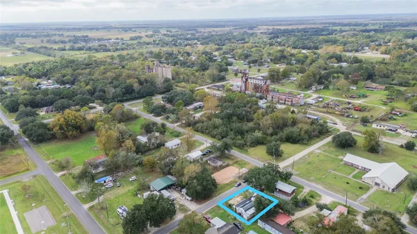 an aerial view of a house with outdoor space pool seating area and yard