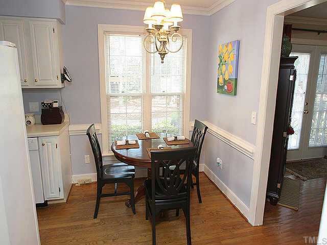 6916 Sandringham Drive Raleigh, NC 27613 - Photo 5 of 8 a view of a dining room with furniture window and wooden floor