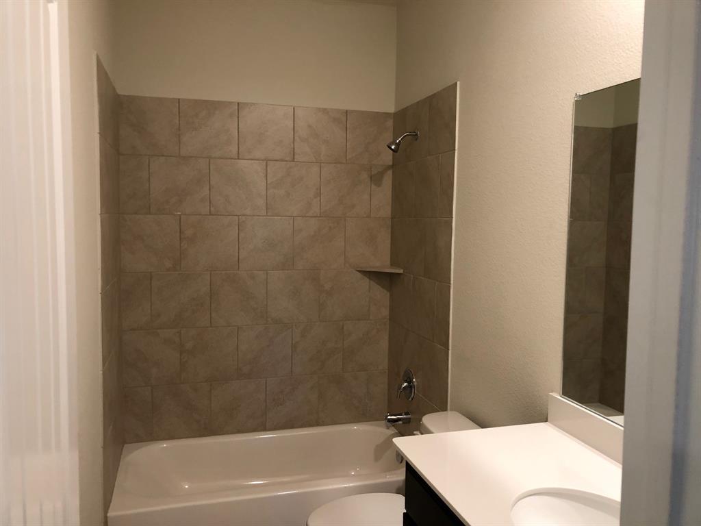 1732 Beasley Street Van Alstyne, TX 75495 - Photo 14 of 17 a bathroom with a bathtub and a shower