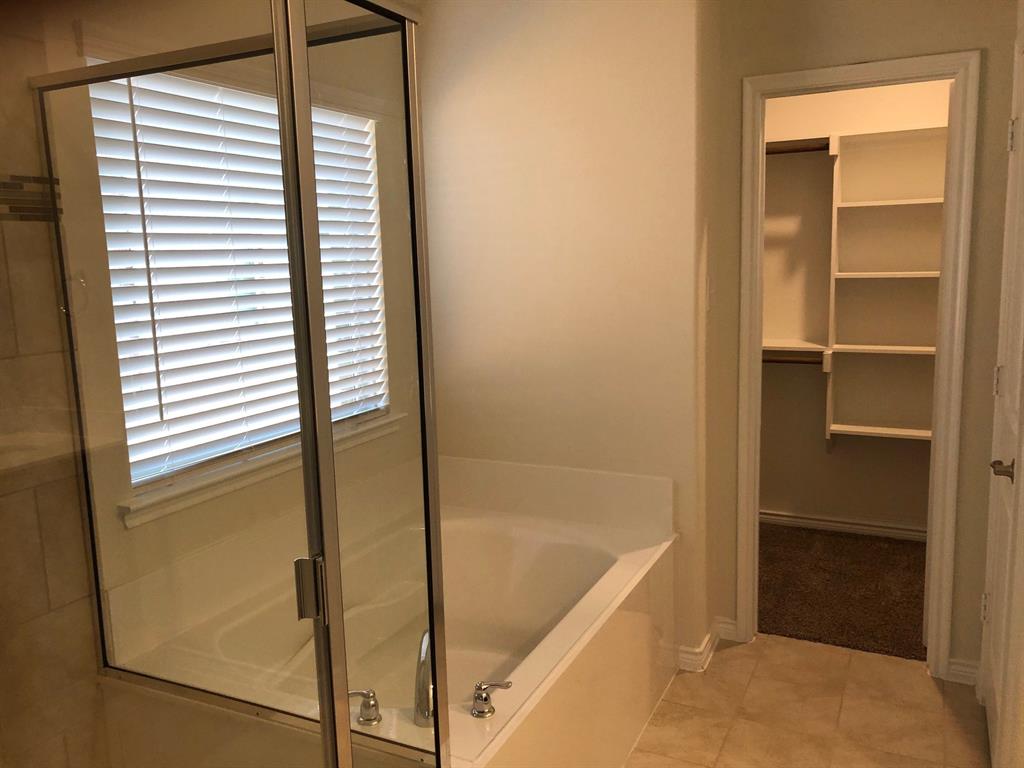 1732 Beasley Street Van Alstyne, TX 75495 - Photo 8 of 17 a bathroom with a bathtub and a shower