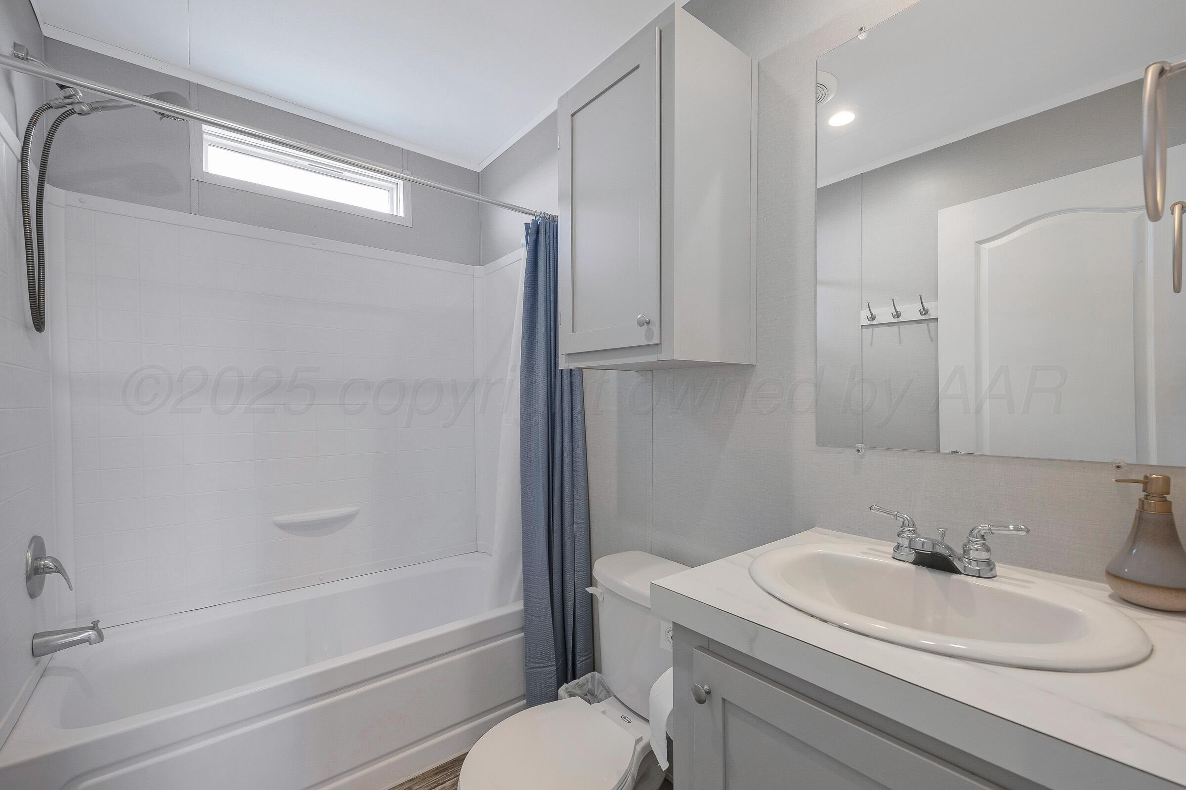 7979 Juett Attebury Road Amarillo, TX 79118 - Photo 17 of 22 a bathroom with a sink toilet and shower