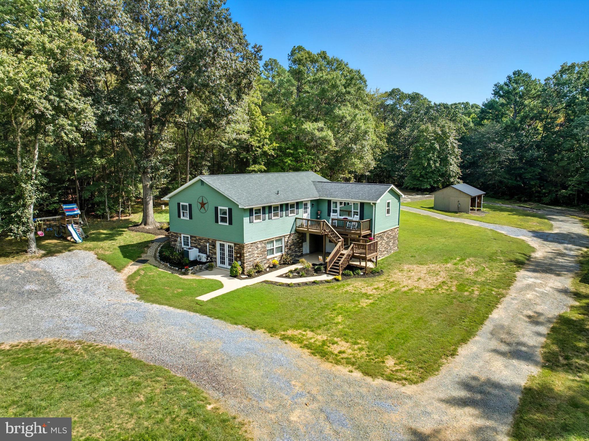 an aerial view of a house with swimming pool and garden