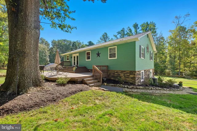 a view of a house with a yard and sitting area
