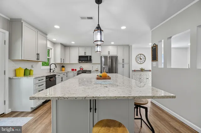a kitchen with a sink a counter space cabinets and appliances