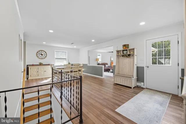 a view of a livingroom with furniture and hardwood floor