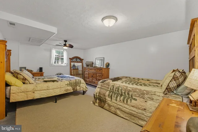 a bedroom with two beds and painted walls