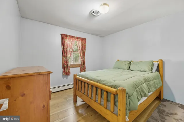 a bed sitting in a bedroom next to a window