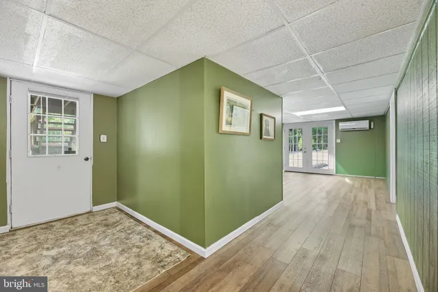 a view of a big room with wooden floor and windows