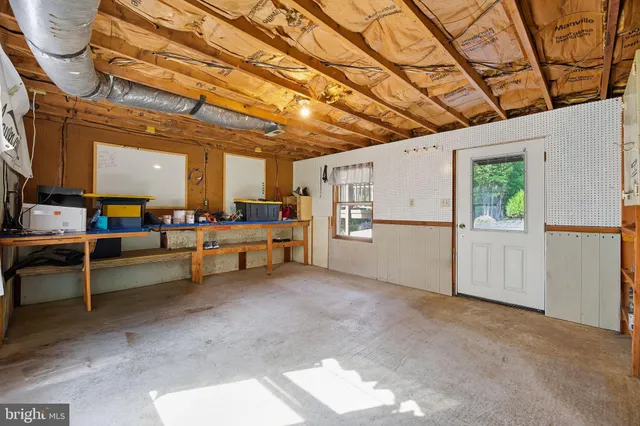 a view of a livingroom with furniture and a refrigerator