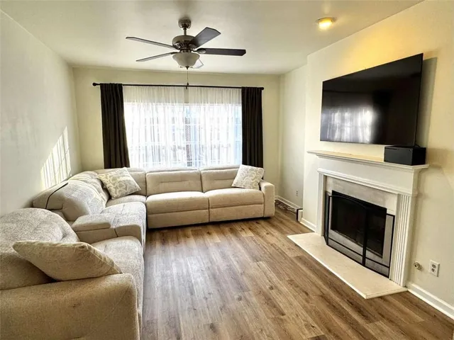 a living room with furniture a flat screen tv and a fireplace