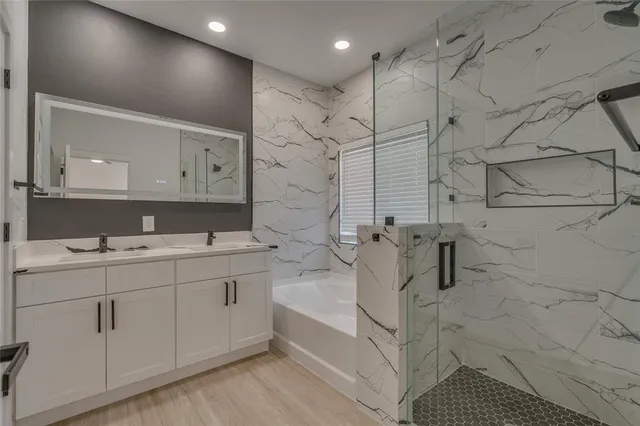 a bathroom with a bathtub and a shower