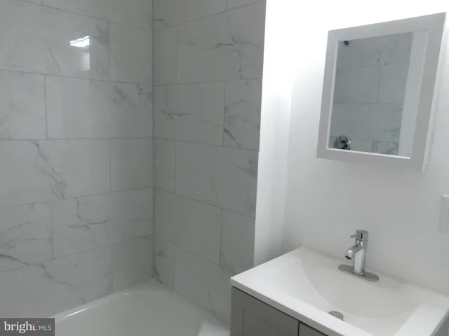 a bathroom with a sink and mirror
