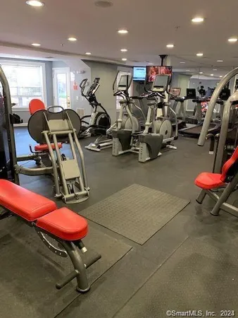 a room with gym equipment and air hockey table