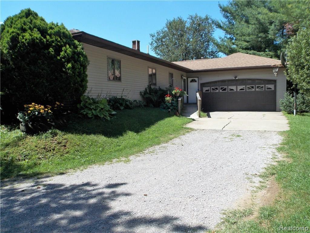 The long winding driveway ends in the 2 car attached garage. The entrance to the home from the garage is into the Laundry room. The large concrete approach will allow the mud to drip off your car before parking inside. The right bay of this garage has an oil change pit, allowing the home mechanic to easily fix anything under his car. An entrance ramp has been added to the home for easier access, but could be removed if steps were preferred.